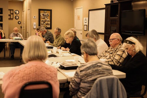 UHBC adults gathered around a table for a small group meeting in Stillwater, Oklahoma