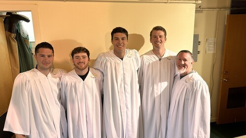 Two young UHBC men smiling together after a baptism service at University Heights Baptist Church in Stillwater, Oklahoma