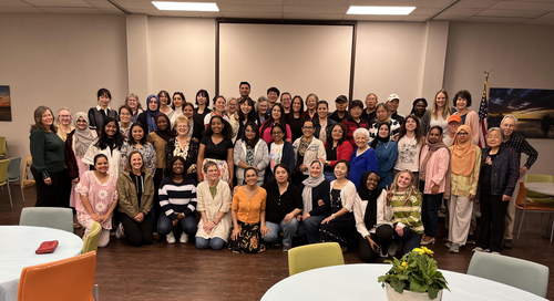 Hands Abroad participants from multiple cultures sharing a potluck meal together at University Heights Baptist Church in Stillwater, OK