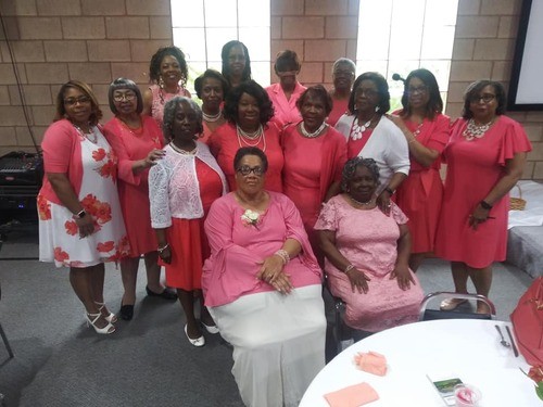 Women posing for photo at women's event