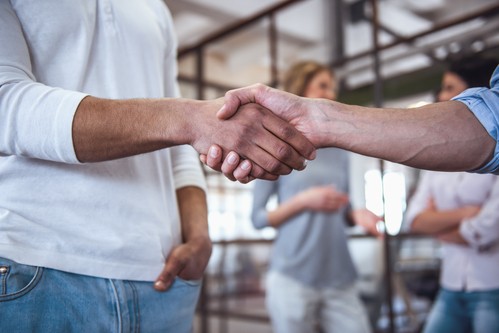 A photo of a visitor being greeted by an usher at New Franklin AG church in Chambersburg
