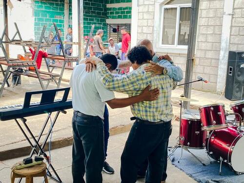praying together in a prison in Honduras