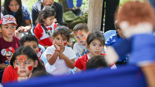 Honduran children enjoying a puppet show at VBS