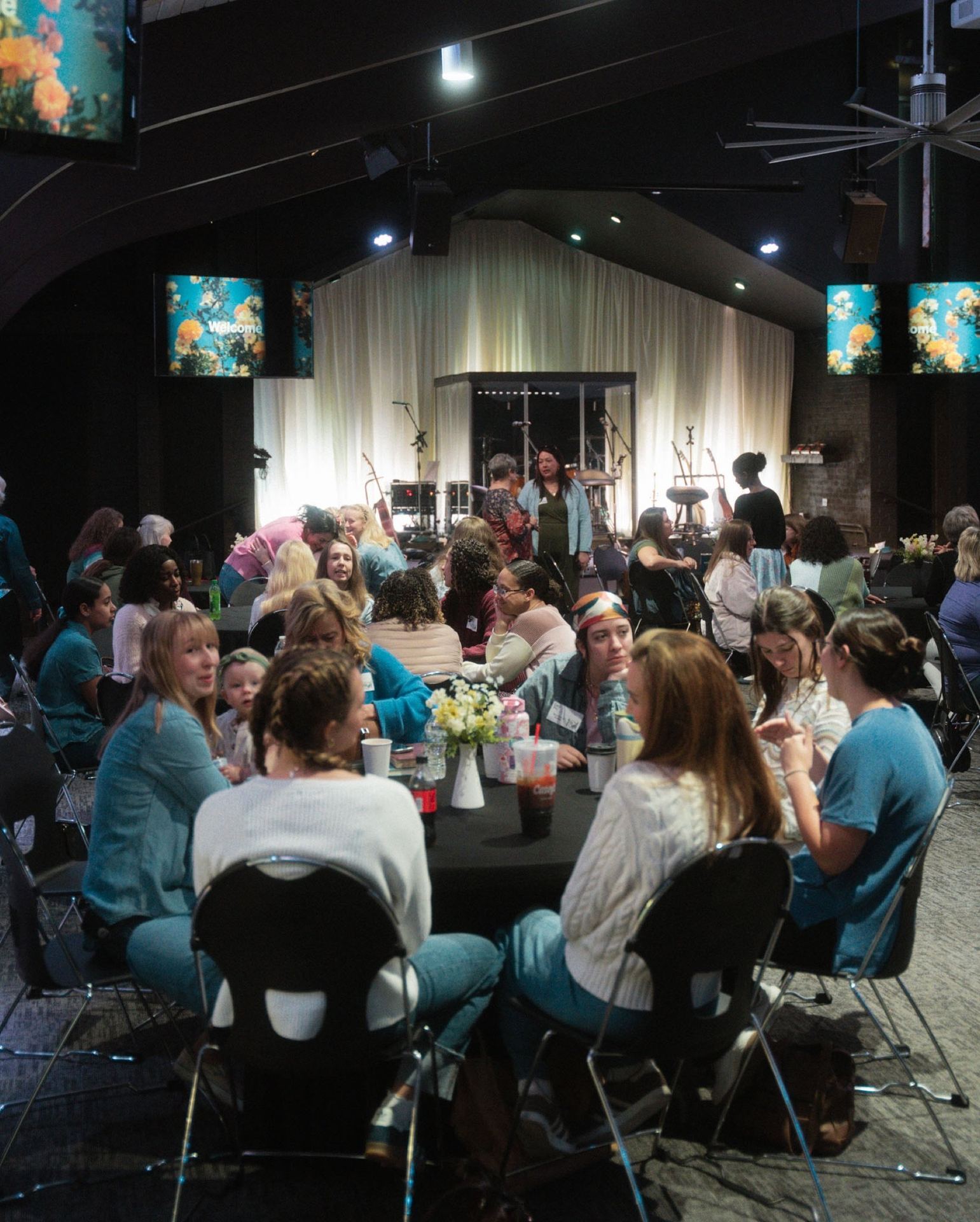 Women talking together around full tables