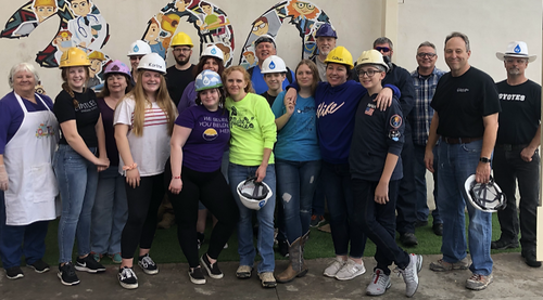 large group of people with hard hats at a church in Mexico preparing to work