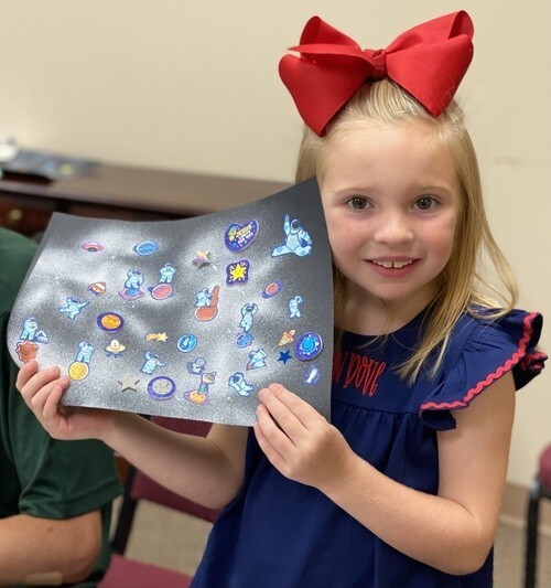 preschool girl with her bible school art
