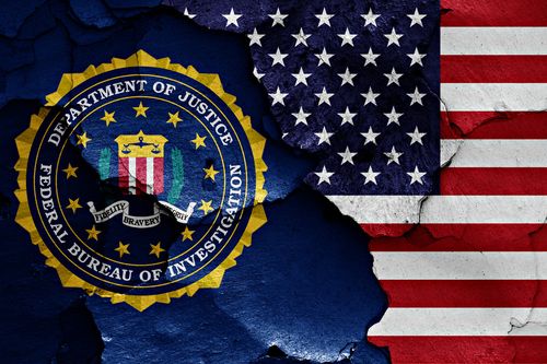 flag of FBI and USA painted on cracked wall
