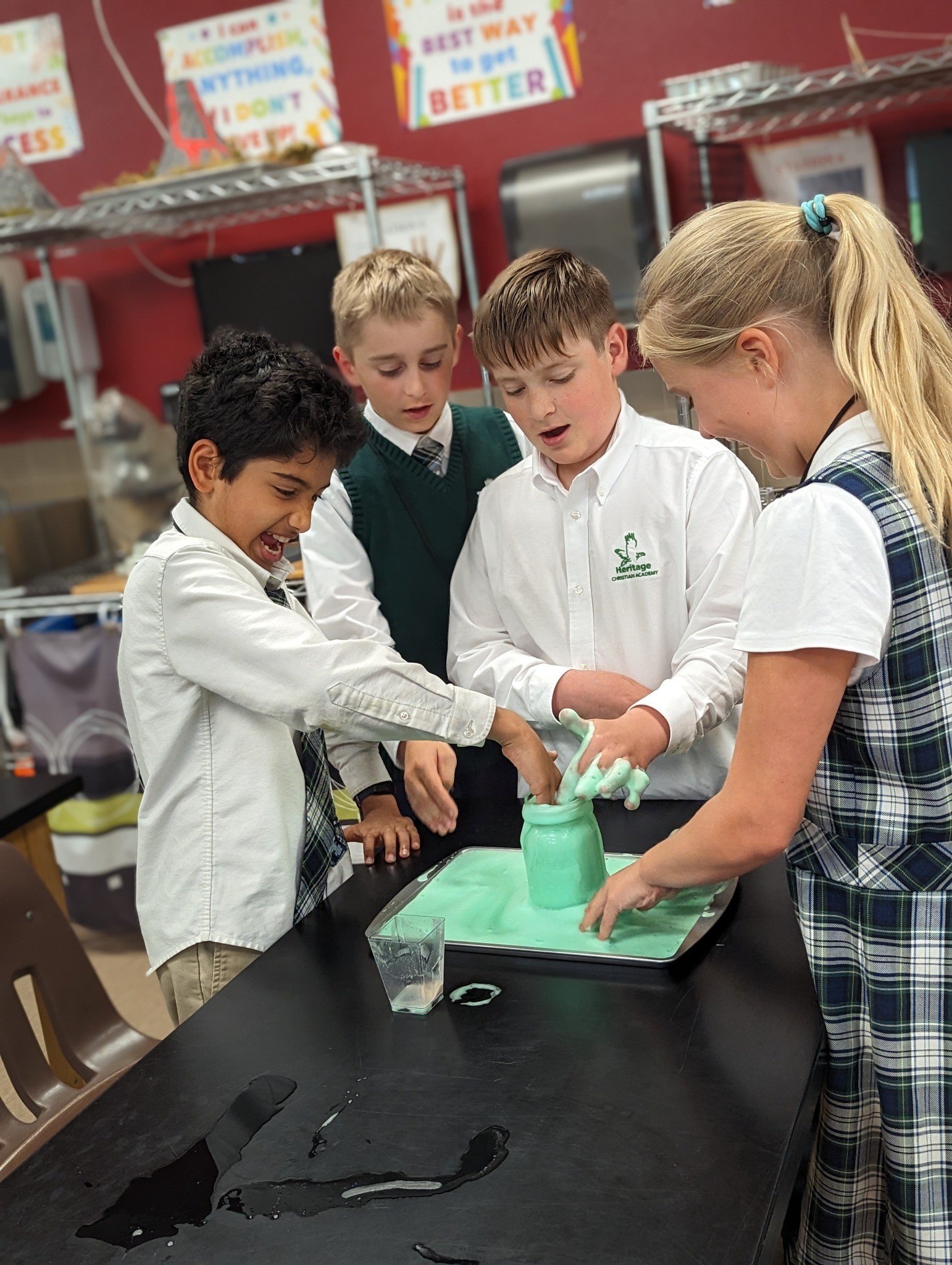 HCA elementary students excitedly exploring a hands-on STEM experiment