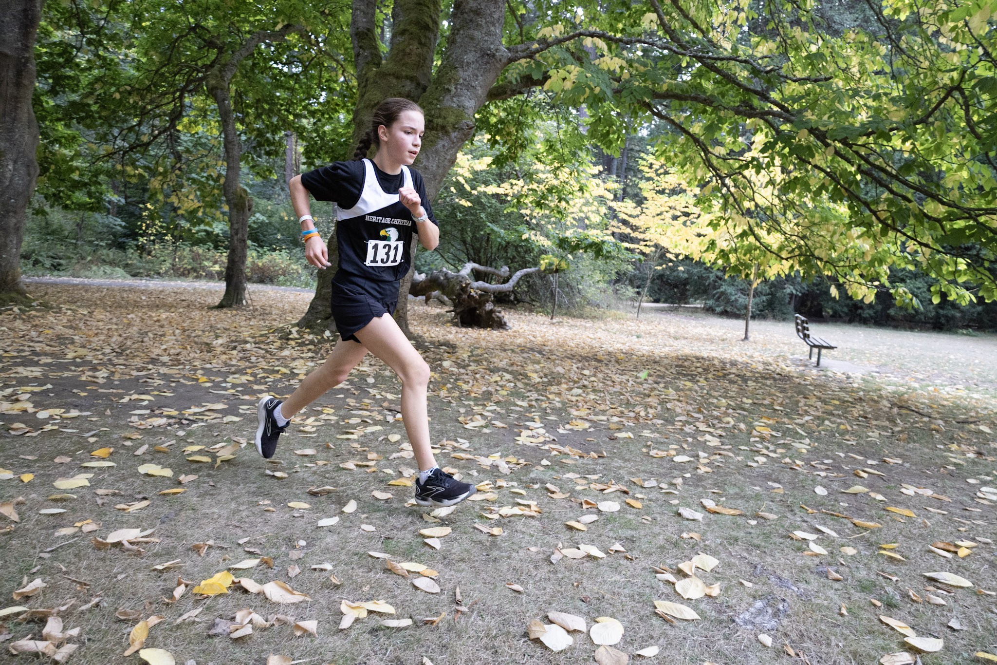 HCA cross-country runner on a wooded trail