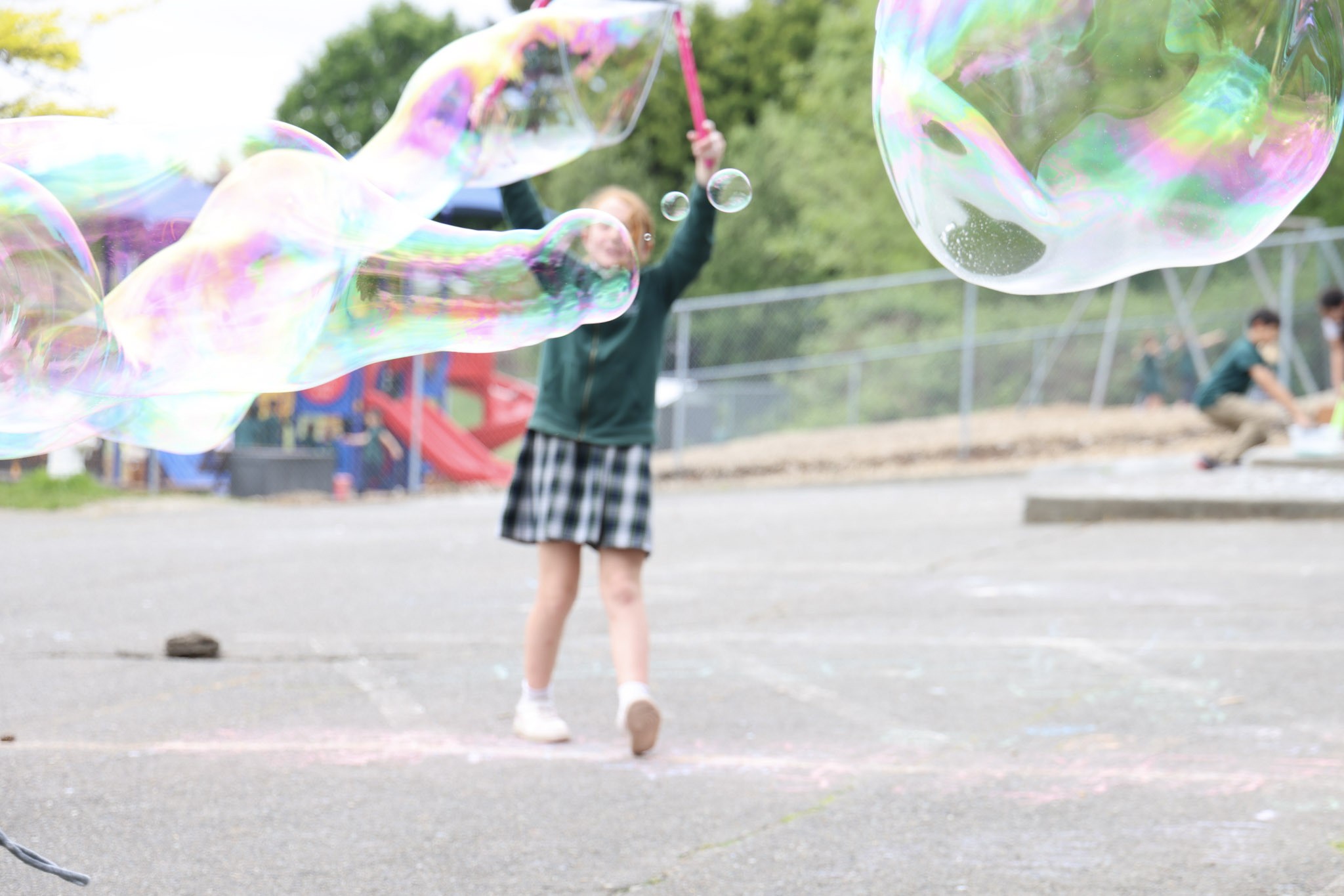 HCA elementary student exploring giant bubbles during a STEM lab activity