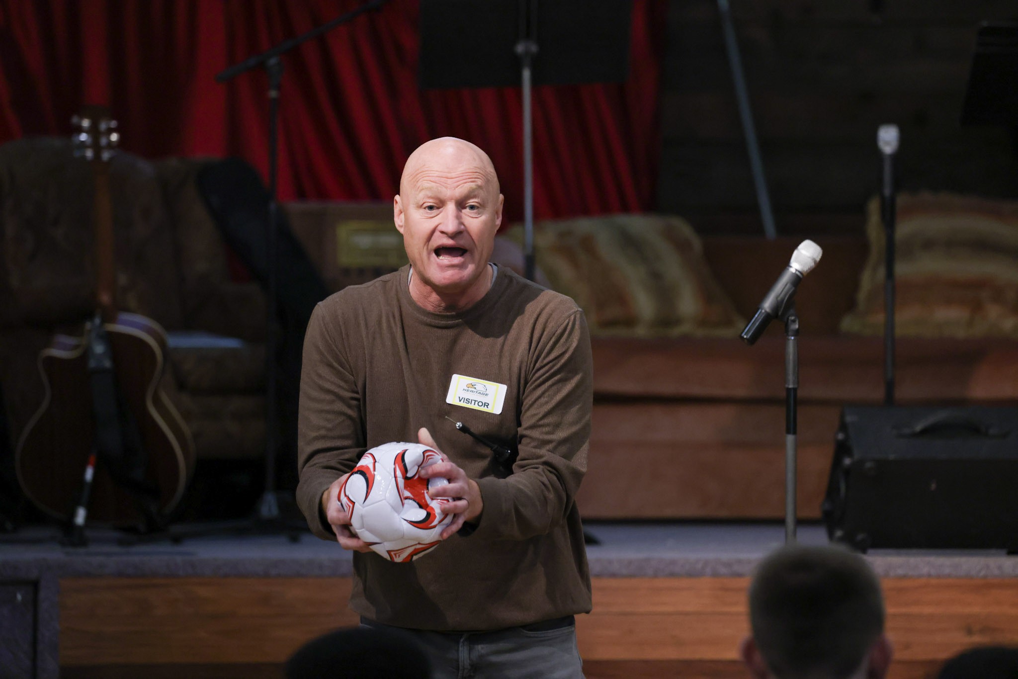 Adventure Soccer guest speaking to students with a soccer ball
