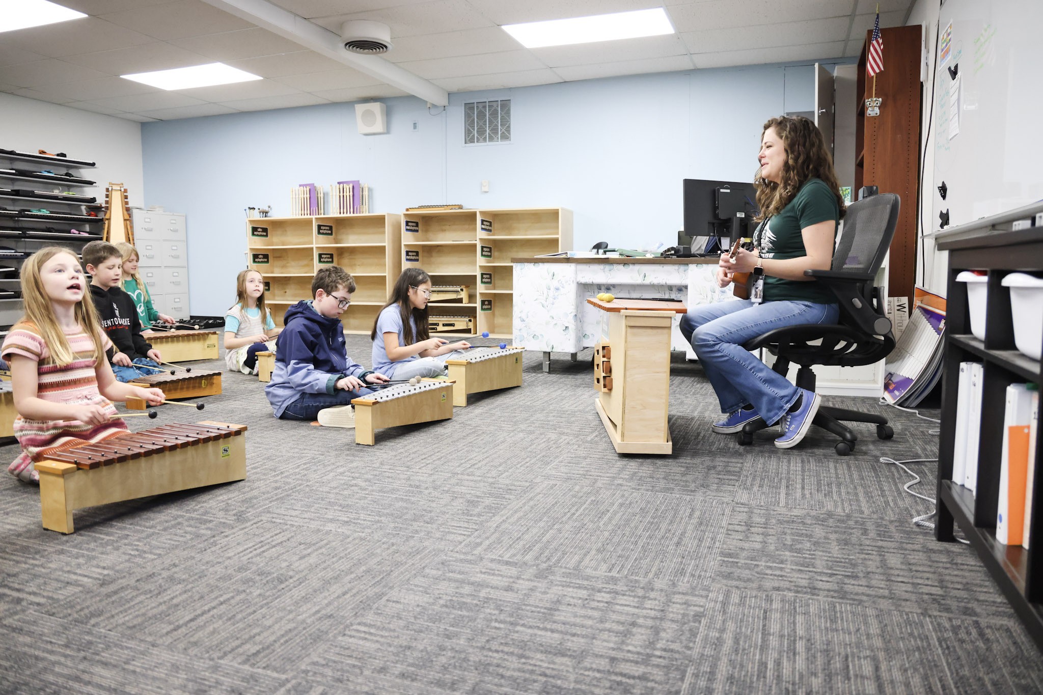 Elementary students playing xylophones with their music teacher