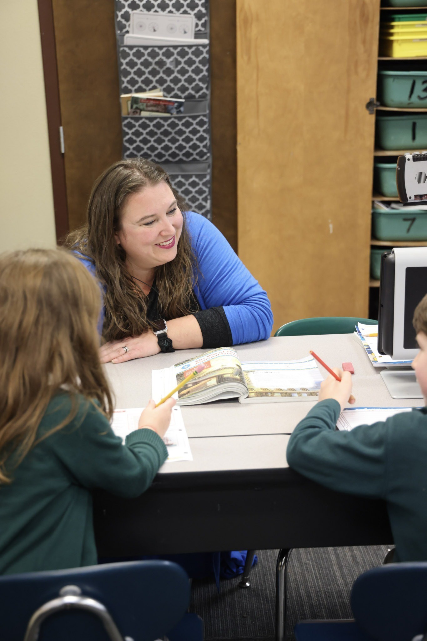 Learning Success Center teacher smiling as she works with HCA students