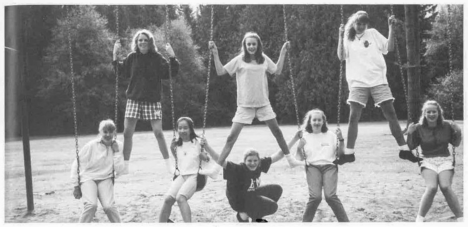 HCA students on playground swings in 1995