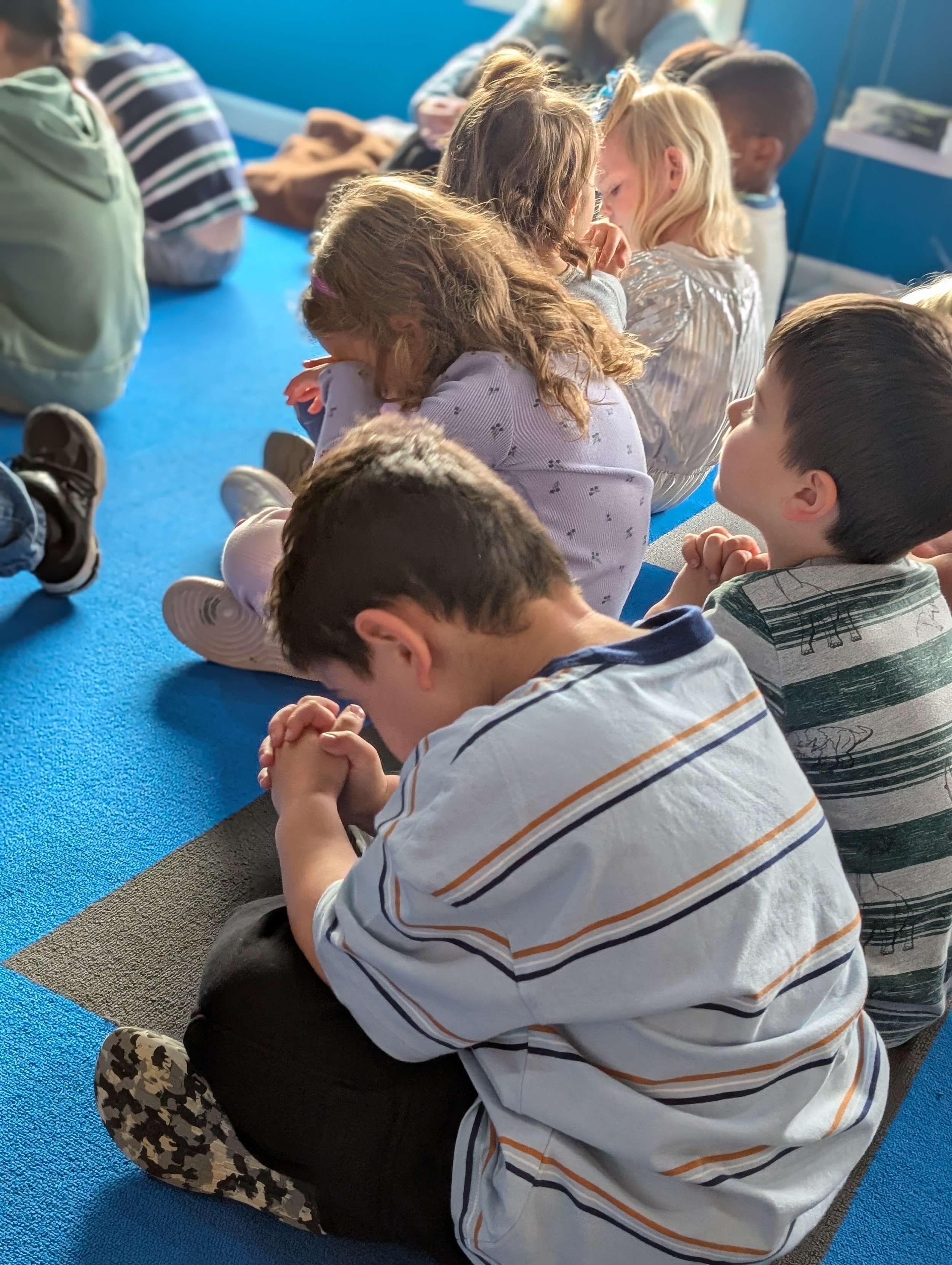 Young Heritage students praying together
