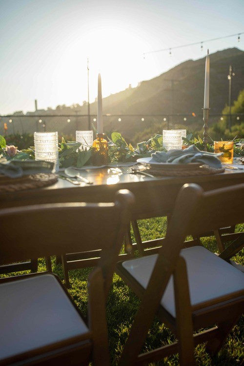 Golden evening light falling across a set dinner table
