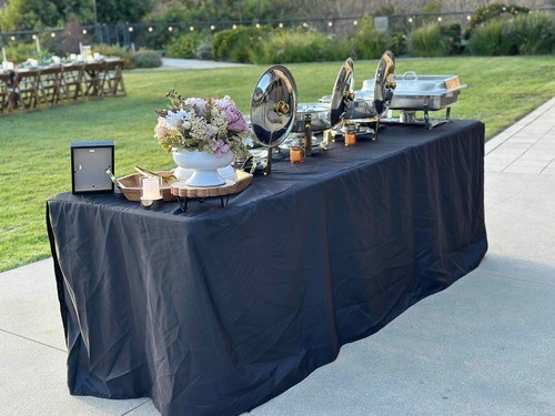 The outdoor buffet station set beside the lawn before dinner