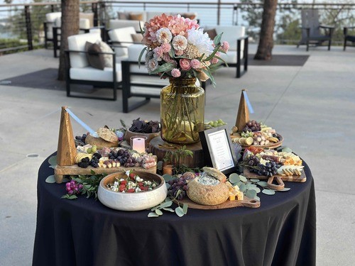 A floral grazing table prepared for guests on the patio