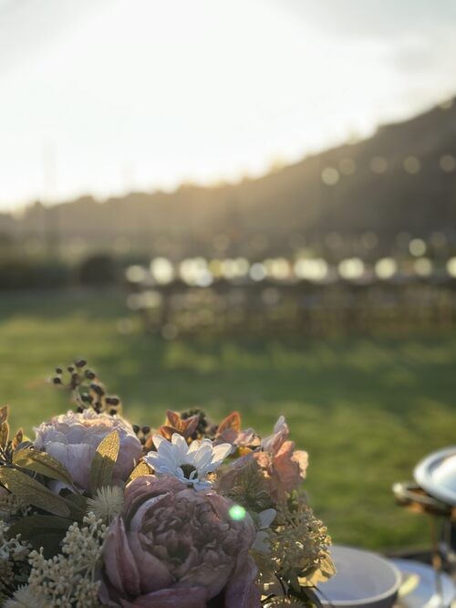 A grazing board detail against softly blurred outdoor seating