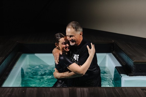 Pastor Bob and Alexandra sharing a hug after Alexandra was baptized.
