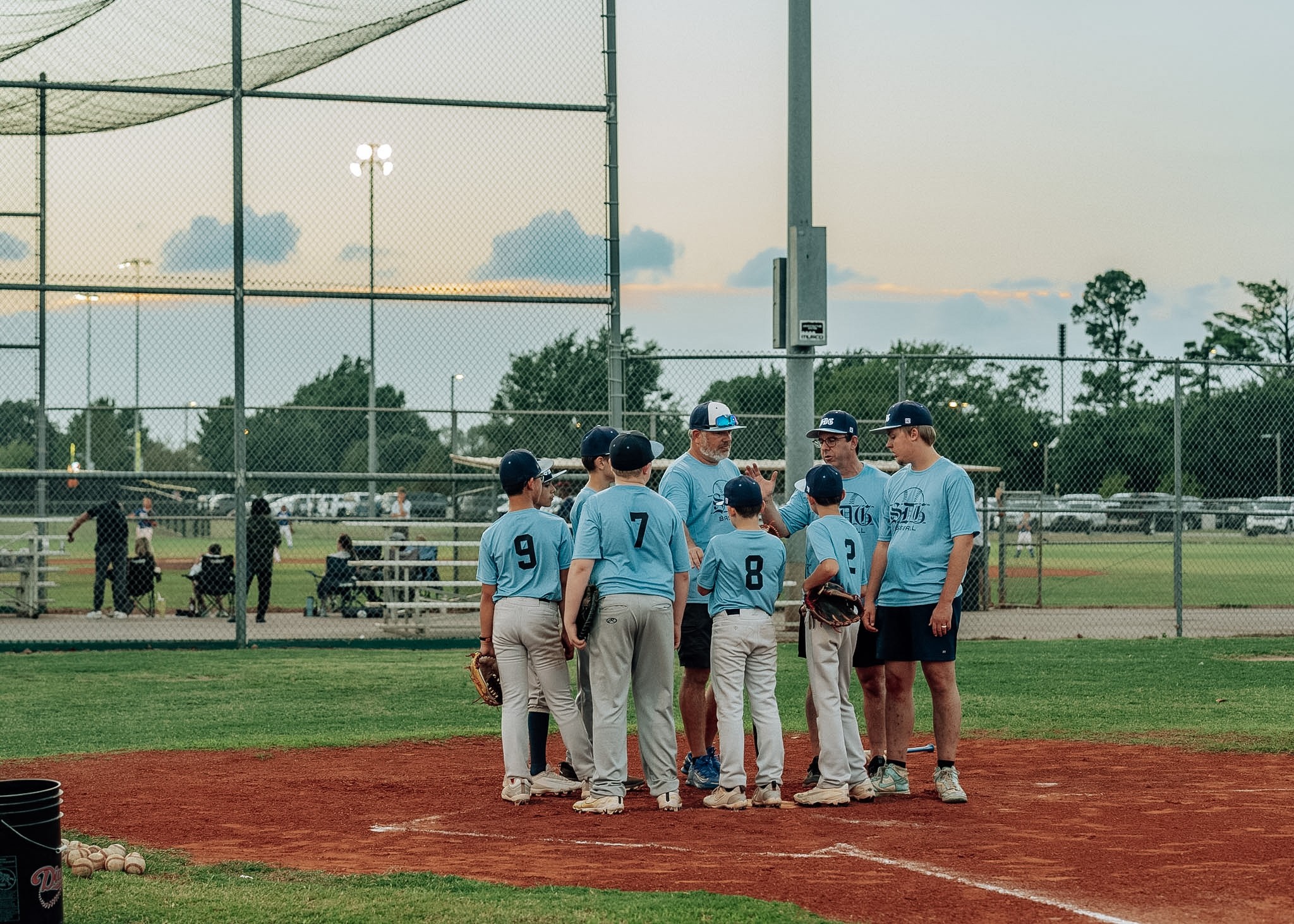 SDG Baseball players gathered around their coaches during fall camp
