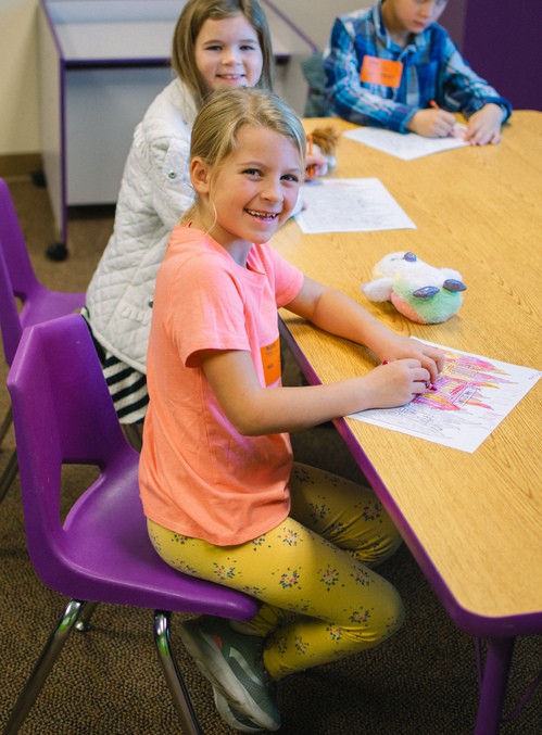 A Child smiling while being in childcare