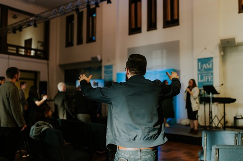 man worshipping during a sunday service at Hope City Church in Providence, RI