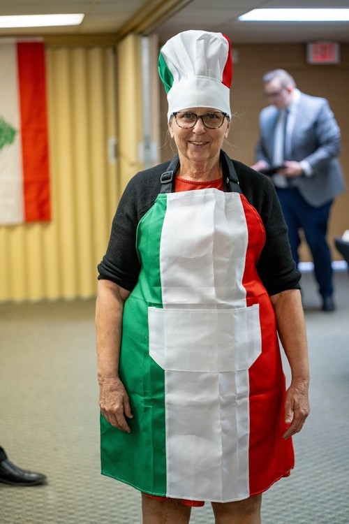 Woman wearing apron with Italy flag on it