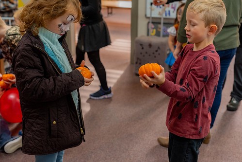 Two children examining pumpkins at the Fall Festival at Creekside Church.