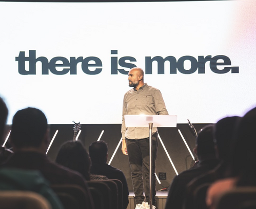 Pastor delivering a sermon at Commission Church in Plano TX. 'There is more' message for the congregation of non-denominational churches in the Dallas area.