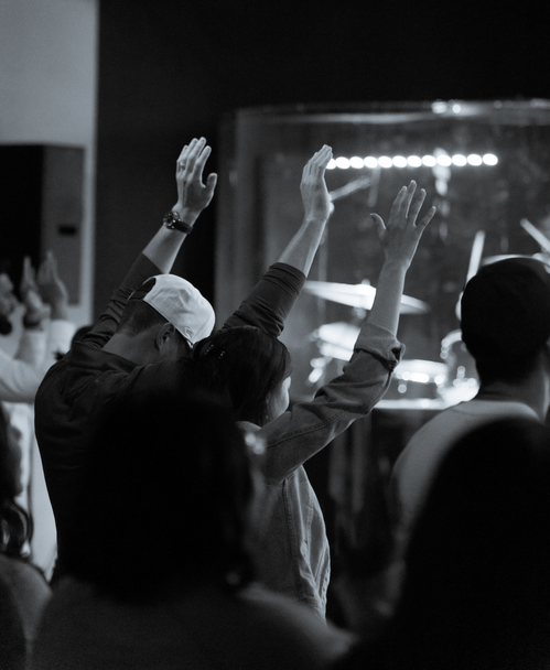 Church members worshipping with raised hands at Spirit Filled Church in Dallas TX - Commission Churches