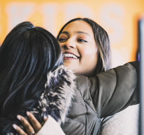 Warm embrace at Commission Church in Plano TX. Non-denominational church members showing love and fellowship in a spirit-filled environment.