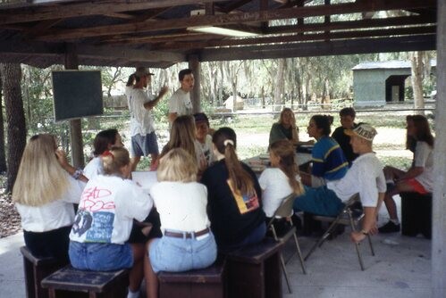 Old picture of people under a pavilion.
