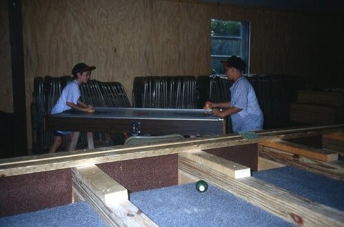 Children playing air hockey.
