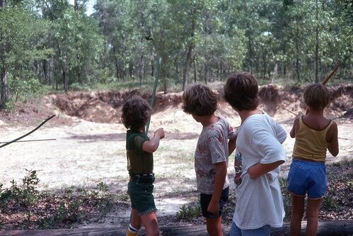 Children playing with sling-shots.