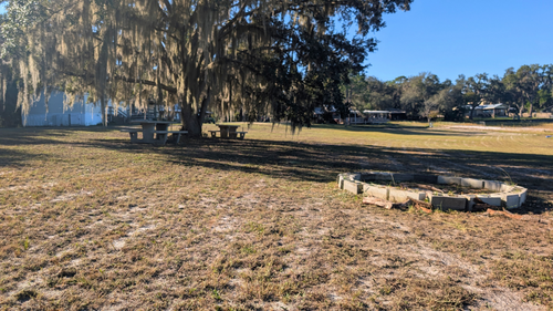 Firepit and picnic tables in front of Live Oak.