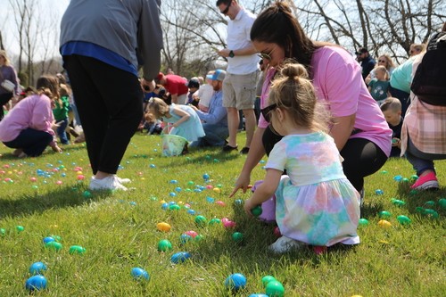 A family hunts eggs at the annual Egg Hunt at New Life Church in Oak Grove, MO