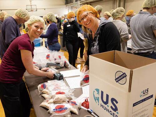 church goers packing food bags for US Hunger
