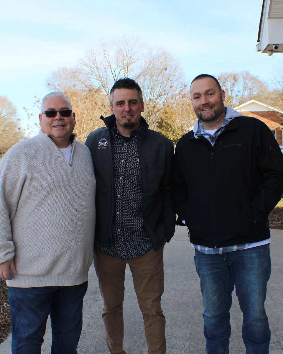 Three members of the Epic Church serve team smiling