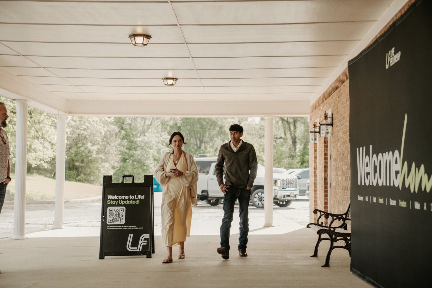 Two guests arriving at the covered entrance of Life Fellowship Chandler