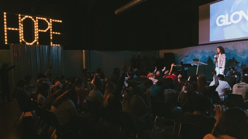 Students worshipping at youth service in Bastrop.