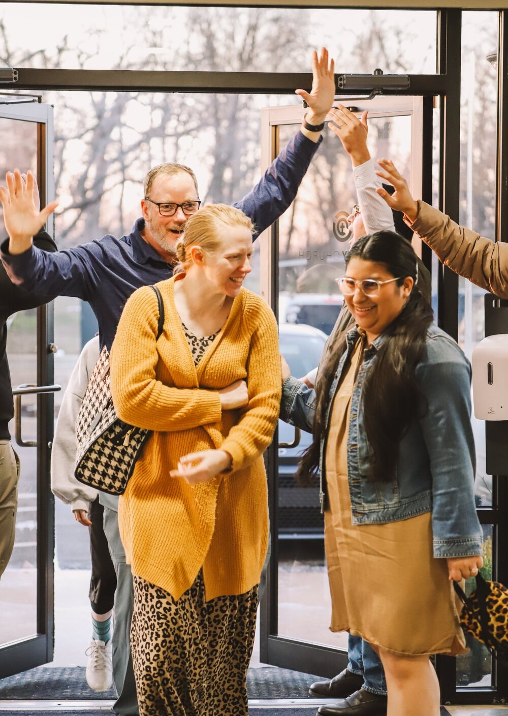Greeters welcoming people at the front doors