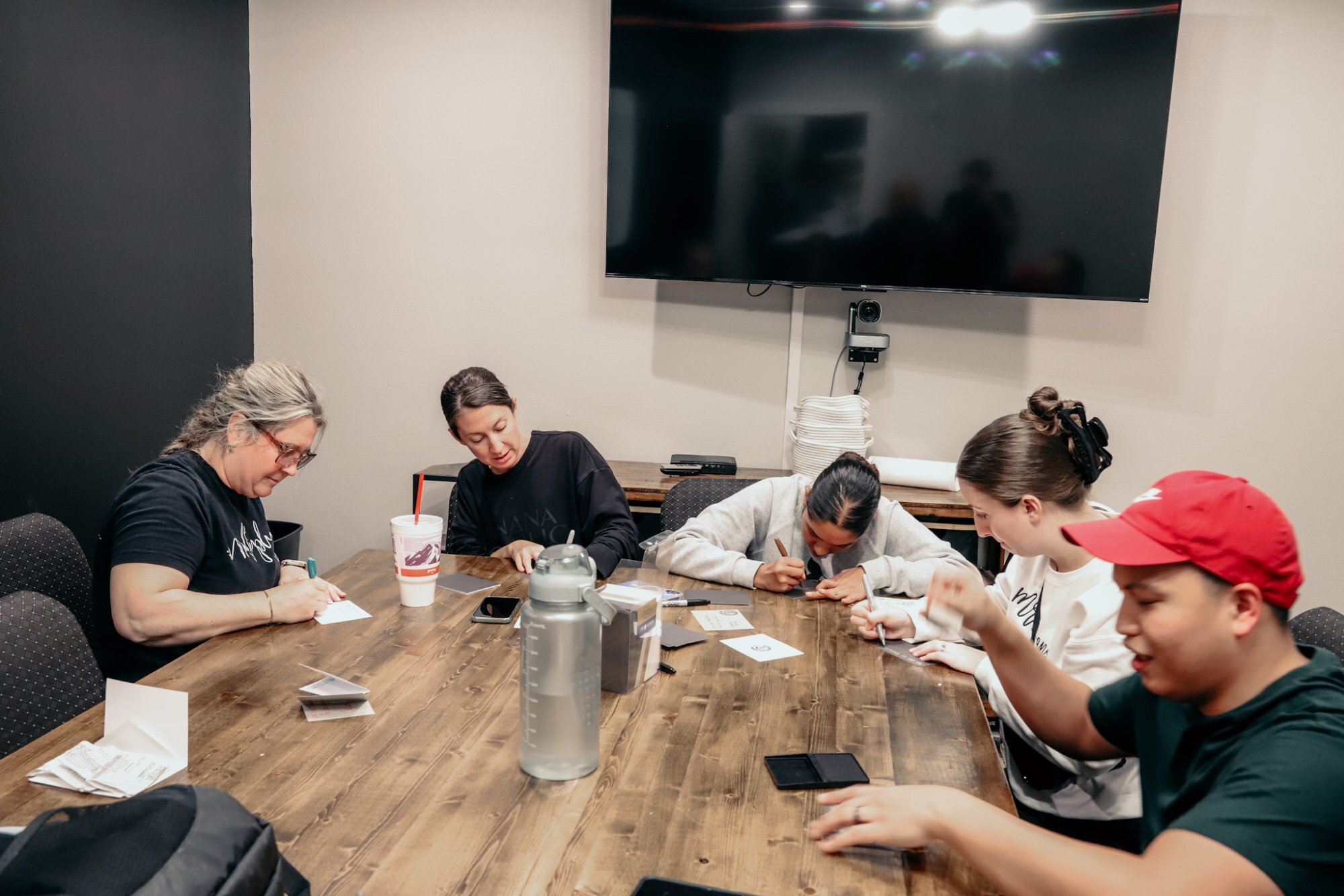 A team writing cards together around a table