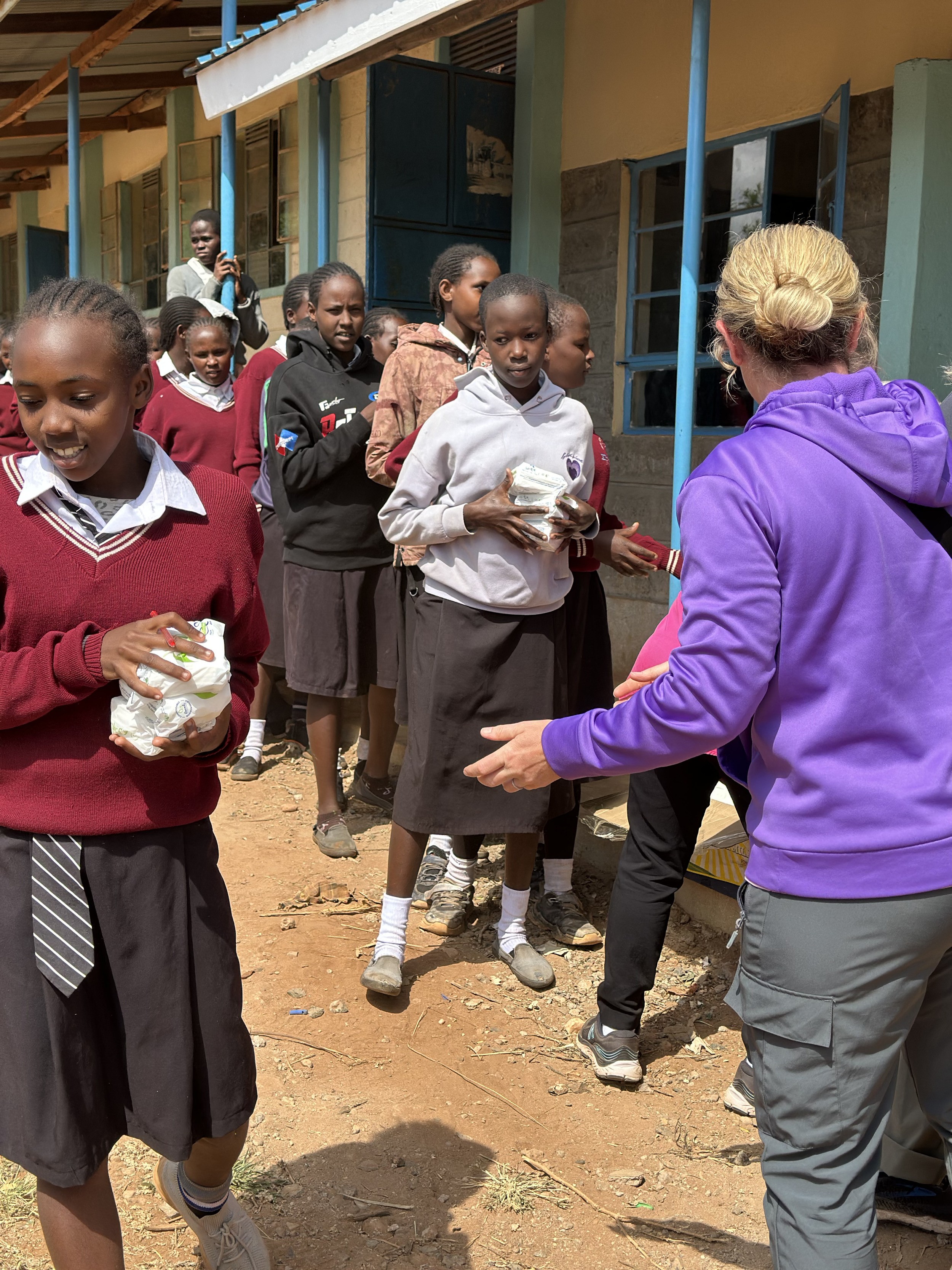 Distributing sanitary towels at Inkati