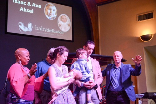A smiling family of a father, mother and two young girls