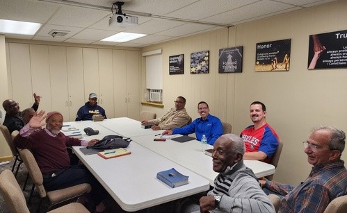 A small group of people around a table with snacks