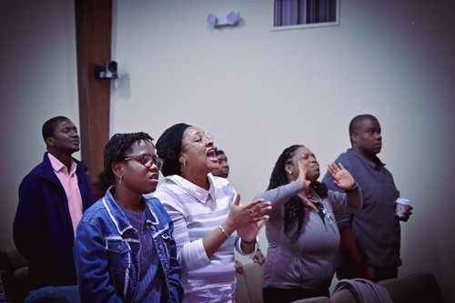 Person worshipping with raised hands