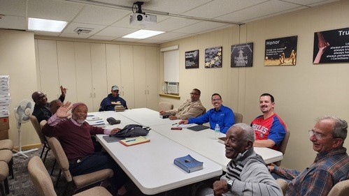 Group of men watching a video presentation