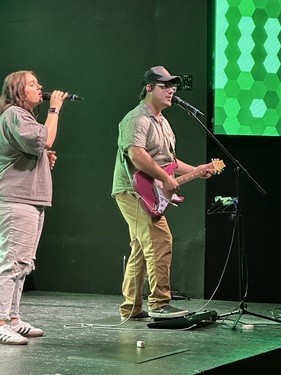 Students leading worship on stage
