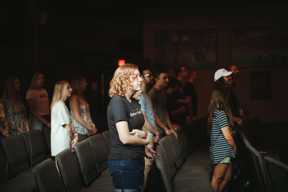 Young adults standing together during worship